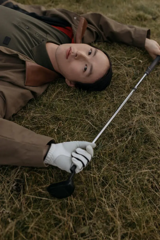 A golfer lying on the grass