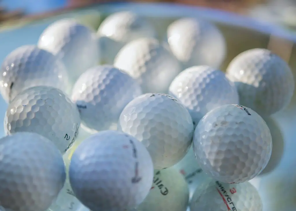 Collection of golf balls close up.
